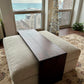 Custom fitted ottoman coffee table sitting in a high rise condo building overlooking the water