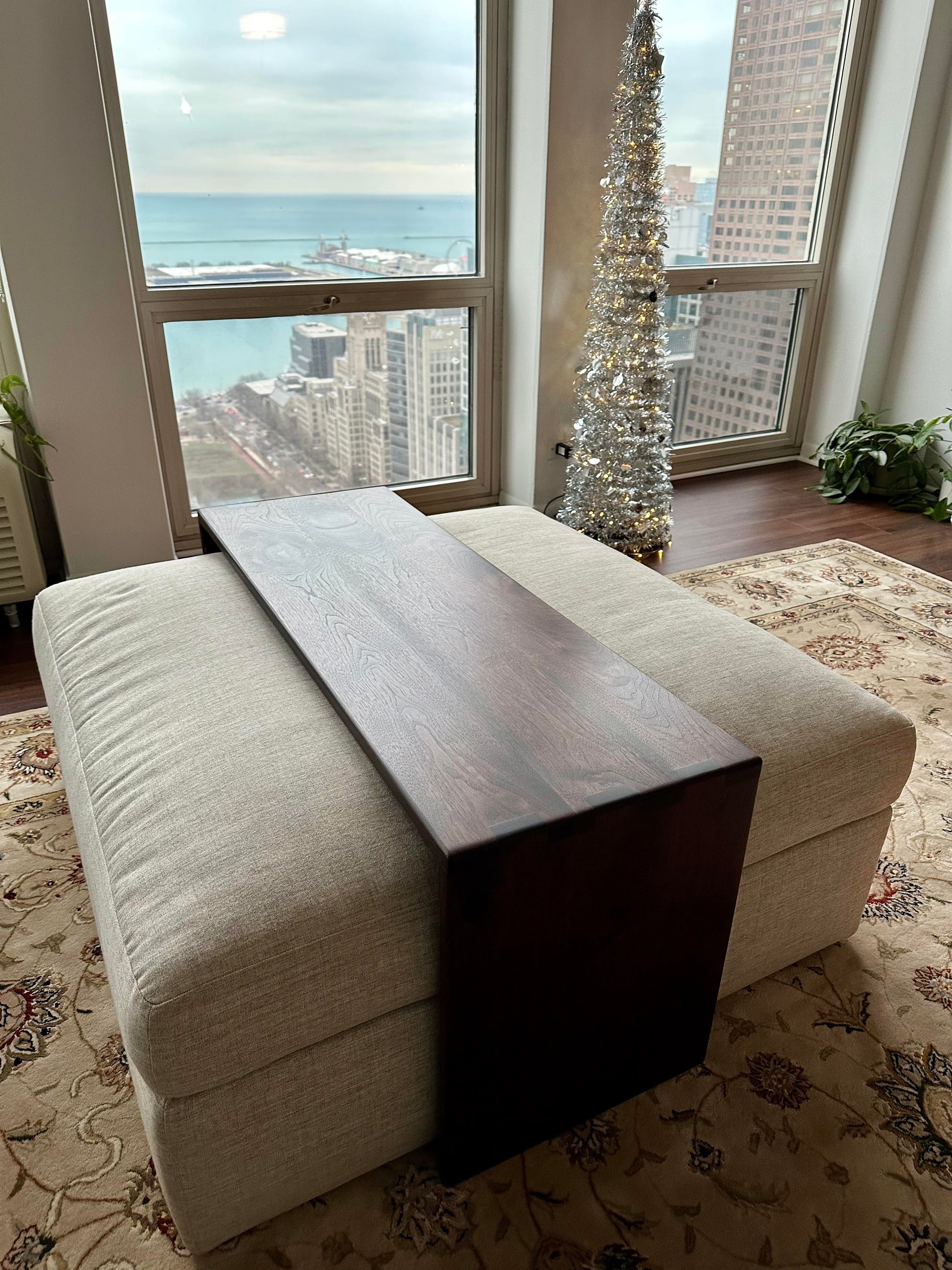 Custom fitted ottoman coffee table sitting in a high rise condo building overlooking the water