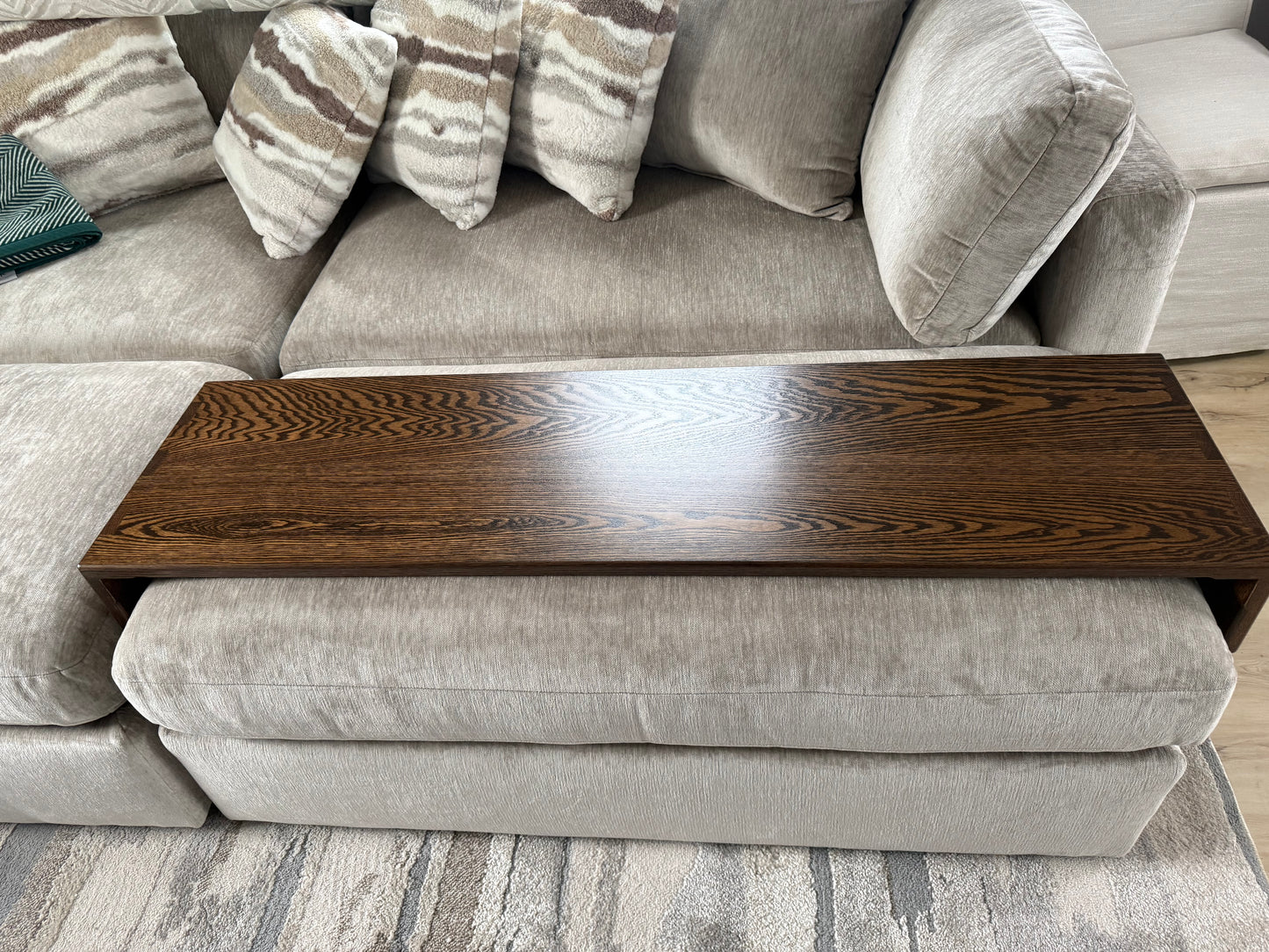 Handmade ottoman table top tray sitting on a clients grey fabric ottoman
