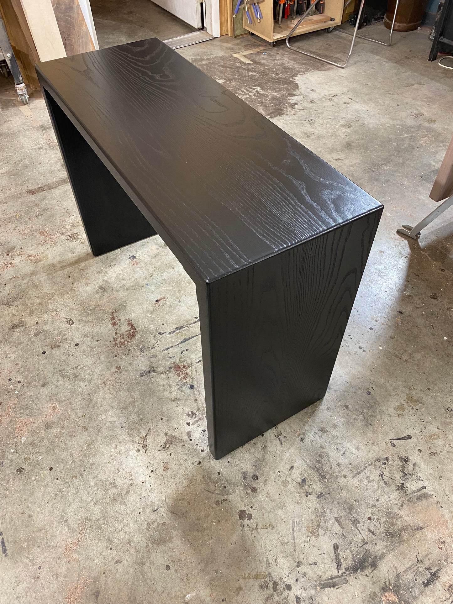 black oak console table with waterfall design, black wood table, entryway table, hall table, waterfall table, narrow table, 36 inch tall table, counter height table, jet black, true black, handmade in columbus ohio, made in america, made in usa, artist, artisan, craftsman, mitered, real wood, solid wood, hardwood, sofa table, accent table, living room furniture, living room table