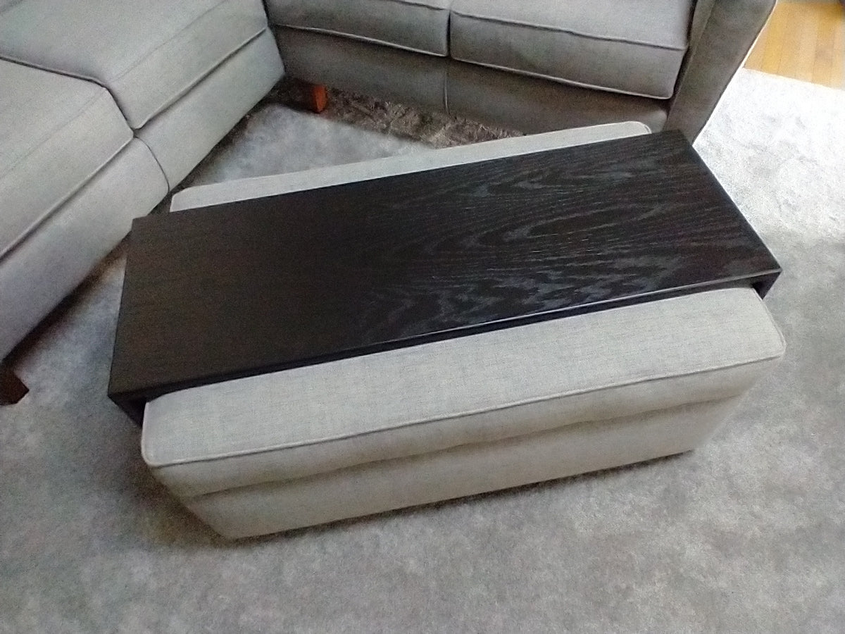 a modern ottoman tray with 6" tall sides. Shown custom fitted over clients grey fabric ottoman.