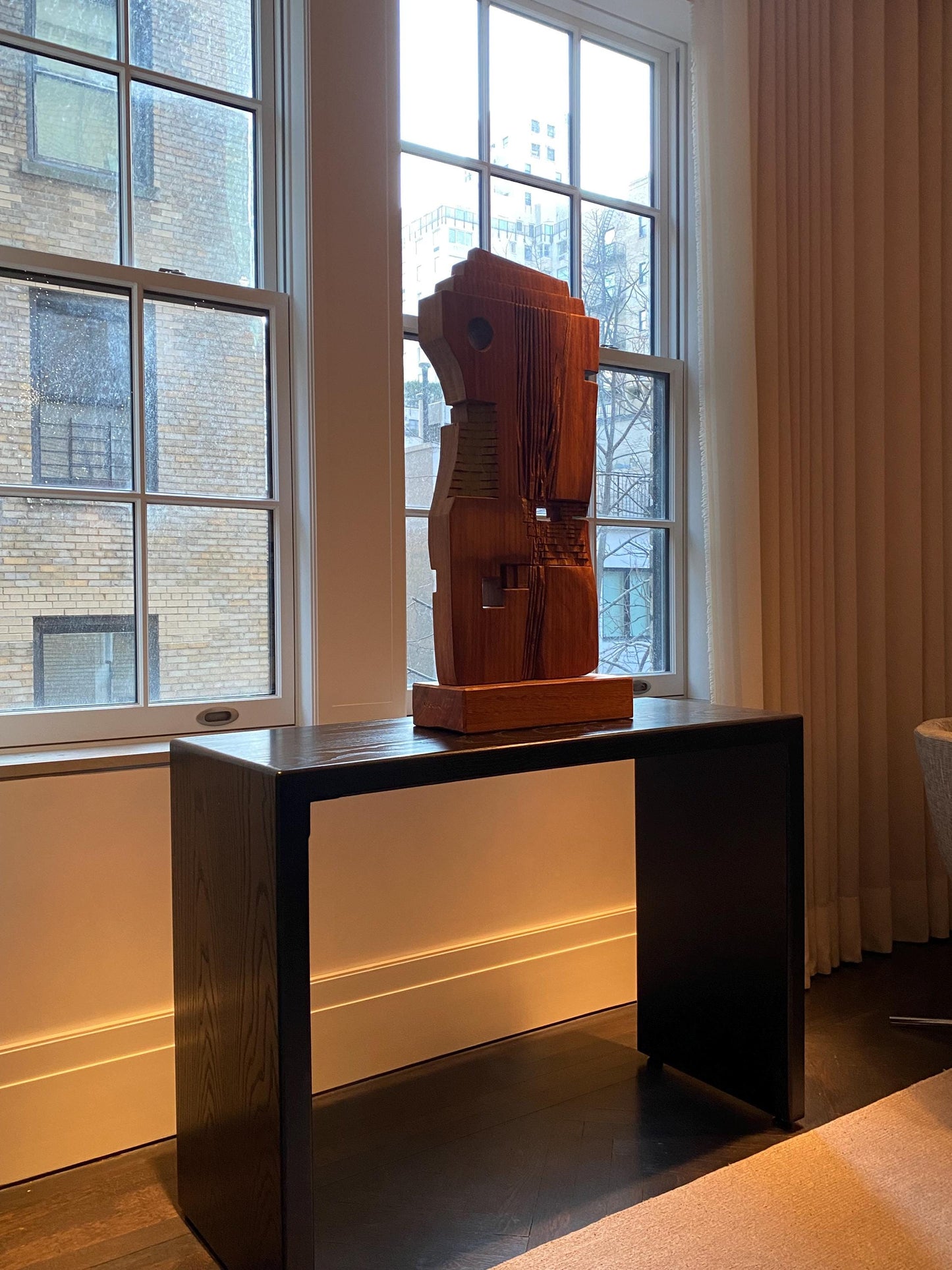 Black console table holding a sculpture in manhattan new york, handmade in america