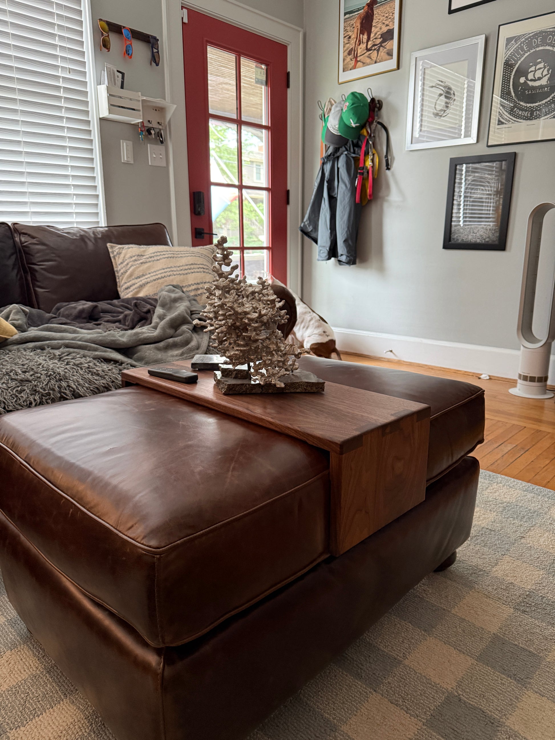 brown leather ottoman with a custom fitted wood tray to set remotes, drink, phones, etc. on
