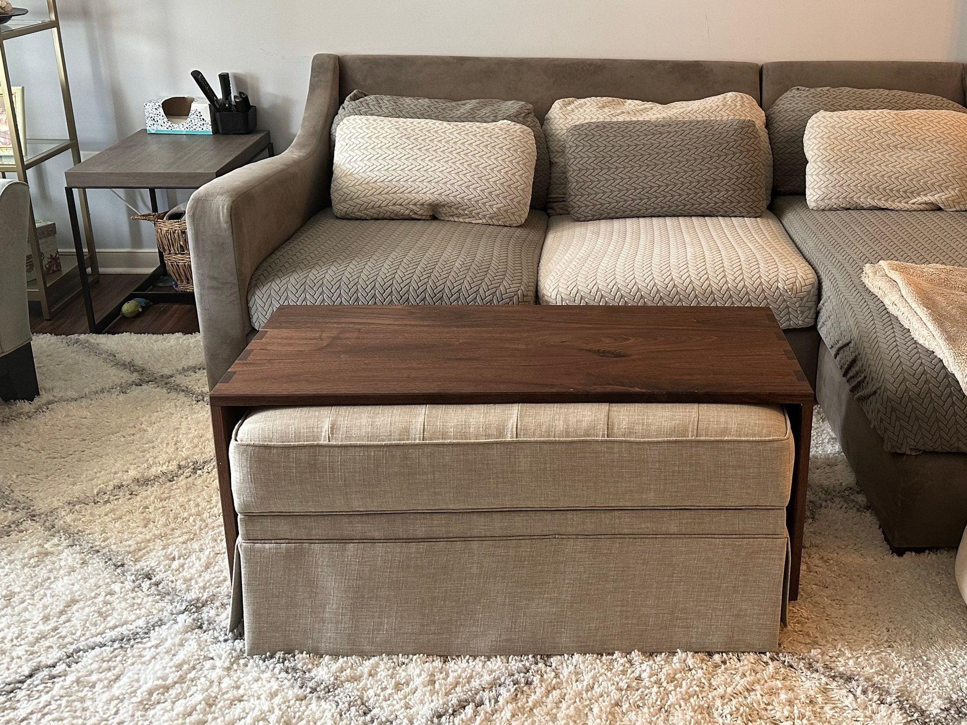 wood ottoman table sitting over customers fabric ottoman