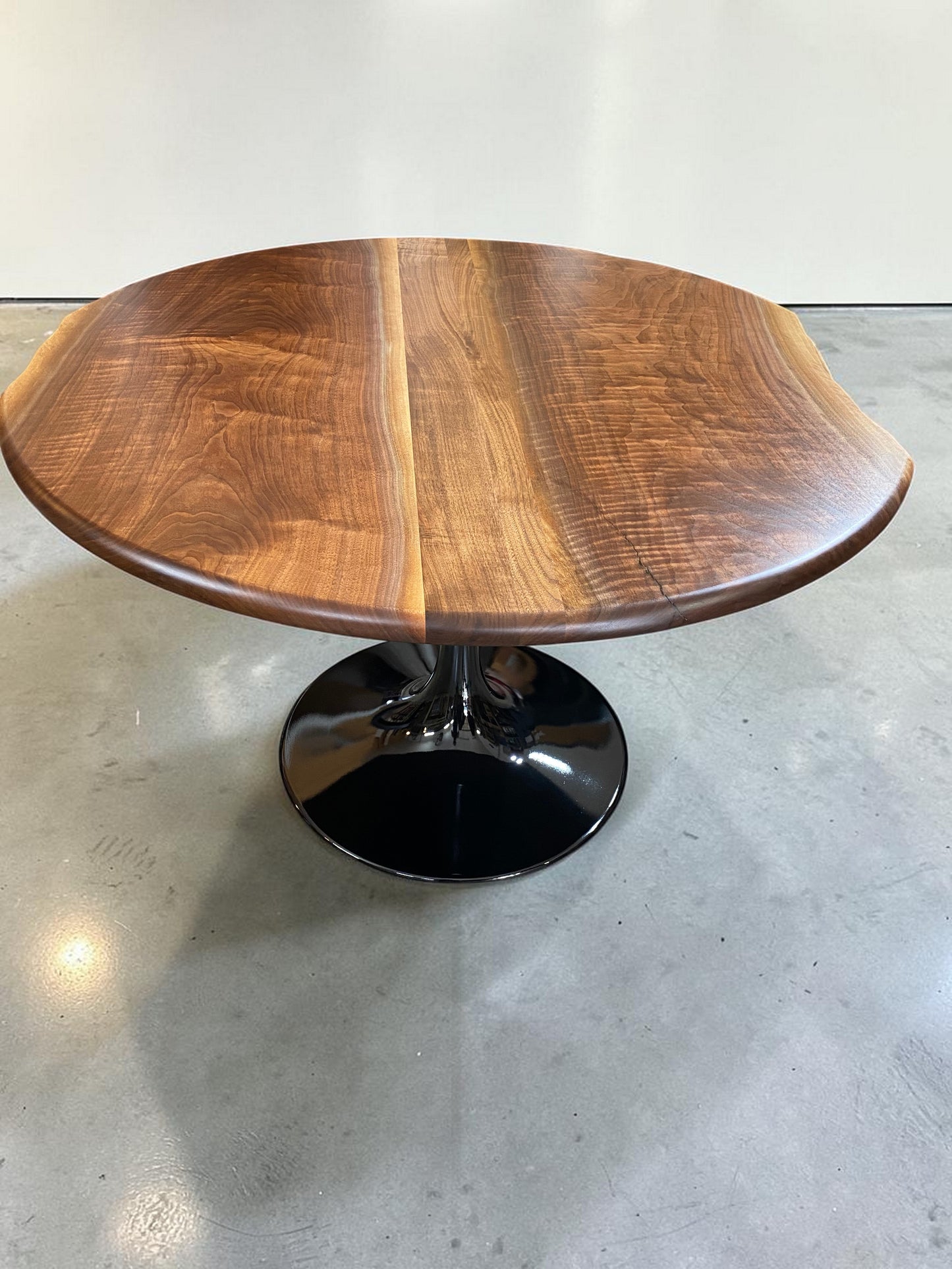 one of a kind round dining table with natural walnut slab slab made in columbus ohio, tulip base, gloss black tulip base, walnut live edge, walnut slab, walnut dining table, hardwood dining table, handmade dining table in ohio, made in use, made in america, local business, small business, luxury furniture, bespoke furniture
