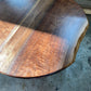 one of a kind round dining table with natural walnut slab slab made in columbus ohio, tulip base, gloss black tulip base, walnut live edge, walnut slab, walnut dining table, hardwood dining table, handmade dining table in ohio, made in use, made in america, local business, small business, luxury furniture, bespoke furniture, walnut in the sun, figured walnut grain, beautiful rays curls 