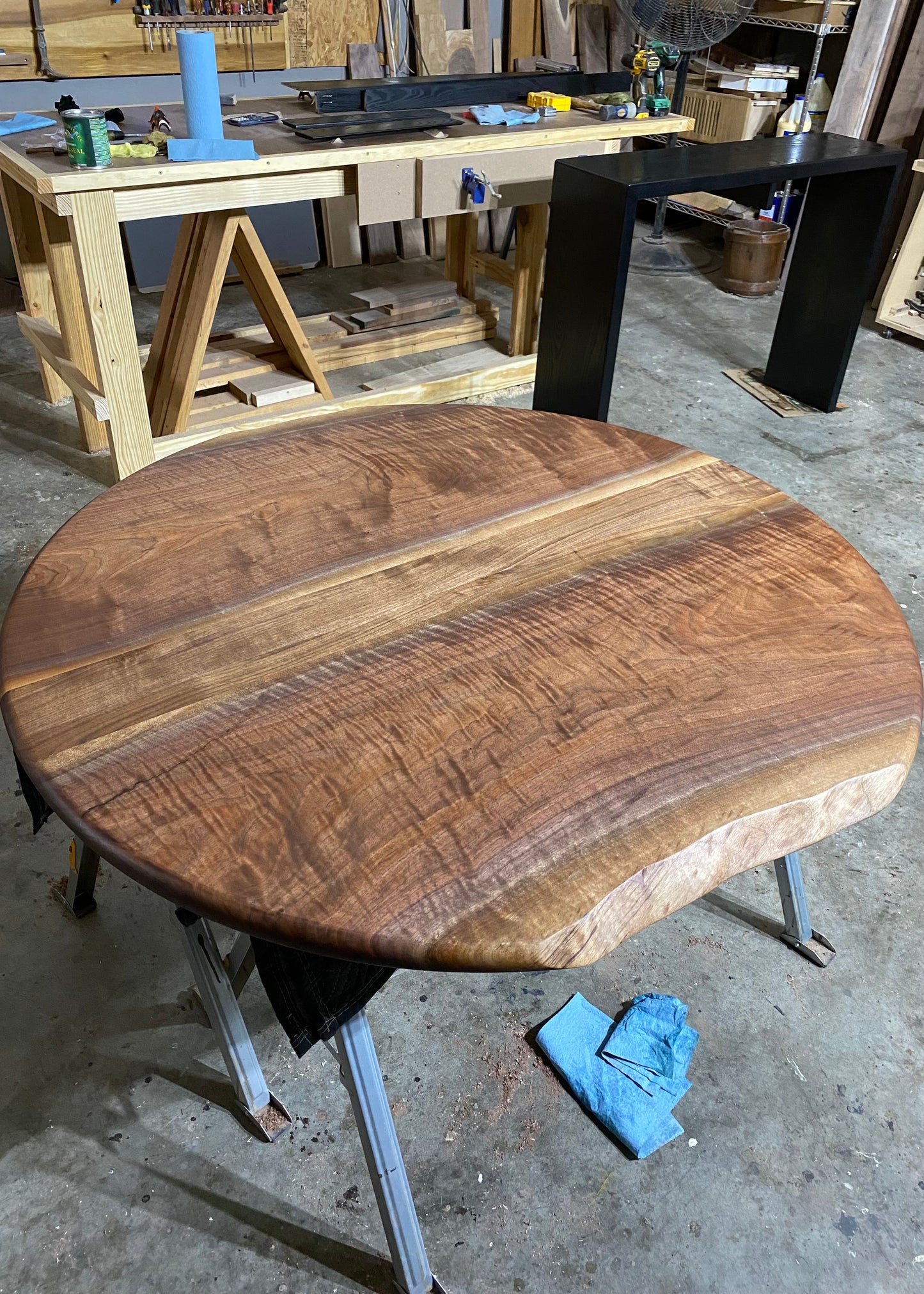 one of a kind round dining table with natural walnut slab slab made in columbus ohio, tulip base, gloss black tulip base, walnut live edge, walnut slab, walnut dining table, hardwood dining table, handmade dining table in ohio, made in use, made in america, local business, small business, luxury furniture, bespoke furniture, walnut in the sun, figured walnut grain, beautiful rays curls 