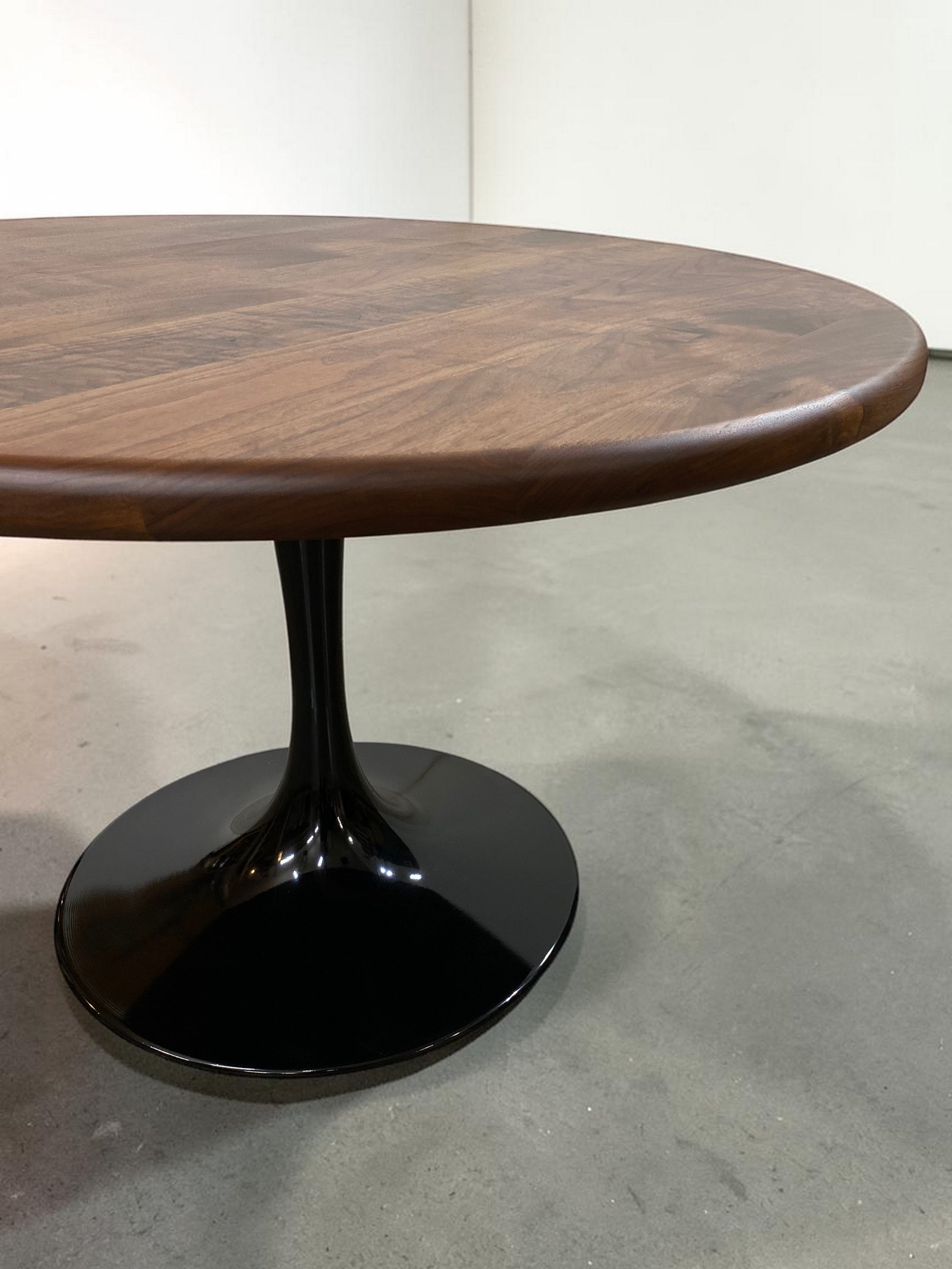walnut wood round dining table with black metal tulip base, handmade in USA, made in america, made in ohio, solid walnut dining table with pedestal base