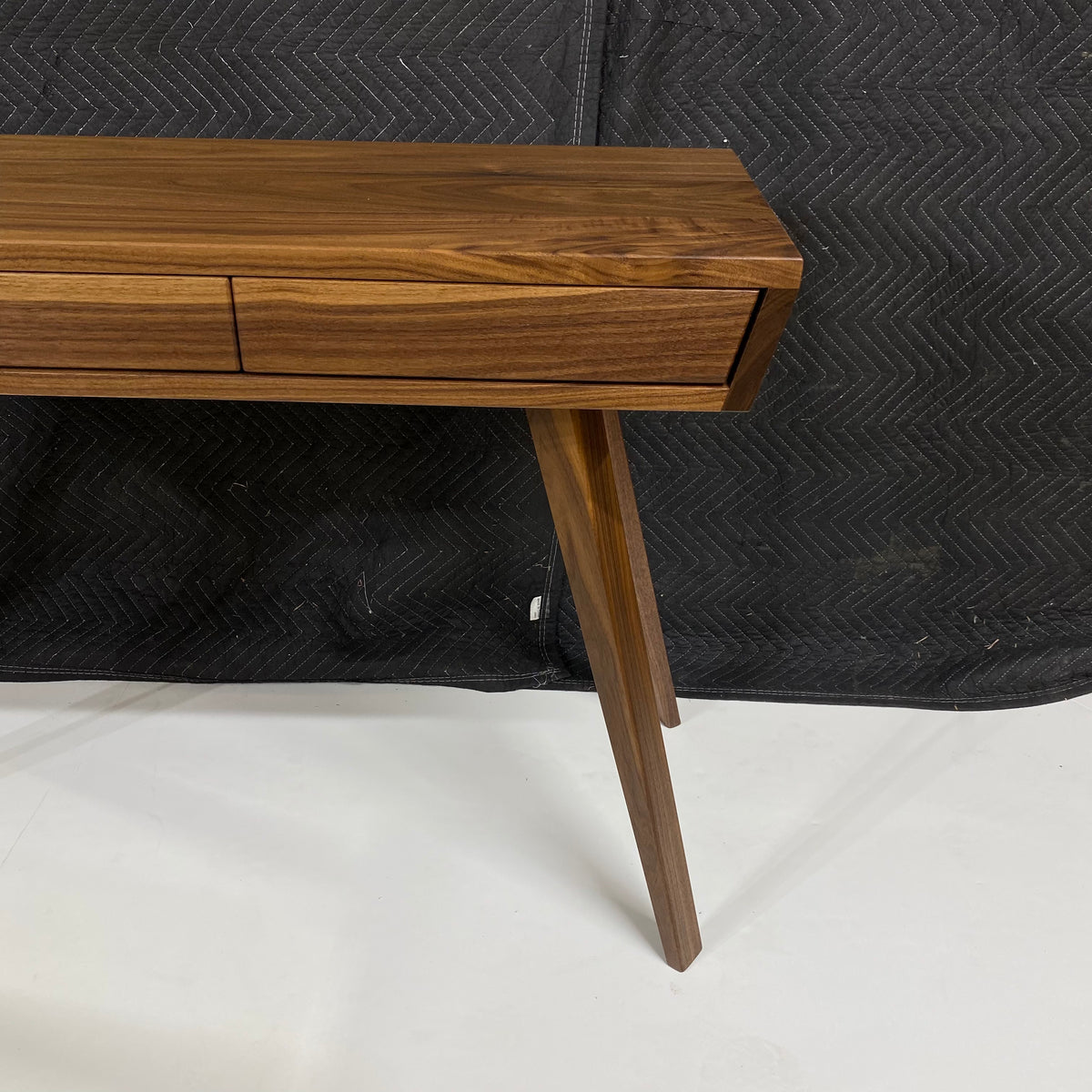 walnut writing desk with modern angled and tapered legs